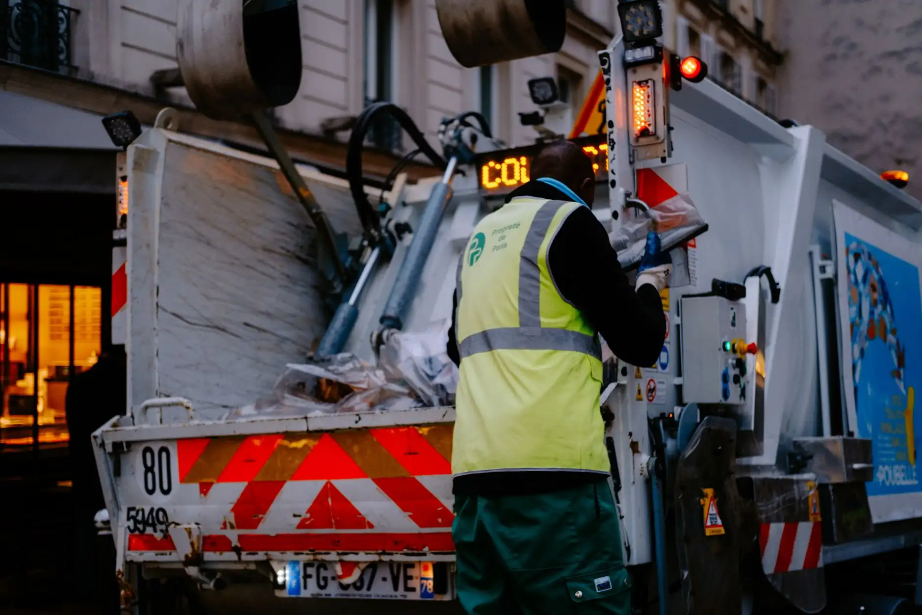 Crew loading waste into a collection truck