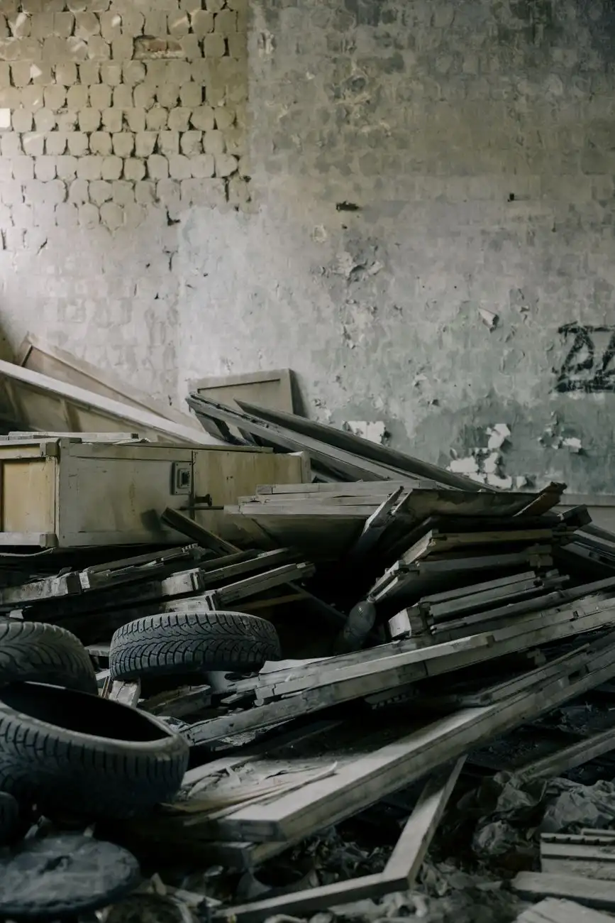 Cluttered storage room with old tires and furniture awaiting removal